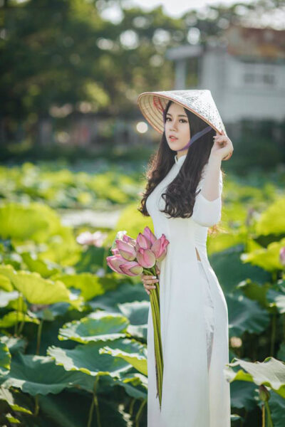 Hình cô gái cầm hoa áo dài trắng